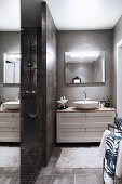 Grey modern bathroom with open-plan shower area and wide washstand