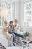 Children with drinks in conservatory