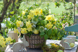 Bouquet of daffodils and spring roses in a basket