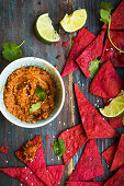 Beetroot torilla chips served with a ful madamous bean dip