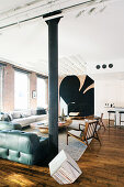 Masculine living area in loft apartment with huge spades symbol in background