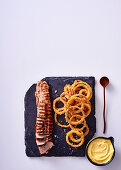 Pork fillet with polenta coated onion rings and aioli