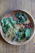 Bowl of dried leaves and berries for making homemade herbal tea