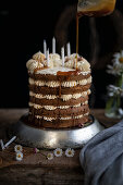 Earl Grey layer cake with Swiss buttercream with caramel being poured on