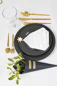 Festive place setting in black, white and gold