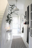 Console table and runner in hallway with white wooden floor