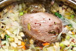 Meat being poached in broth