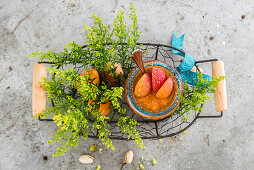 A basket with an apricot jam in a jar