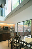 Long, fitted sideboard in double-height dining room