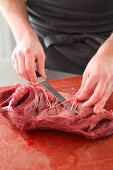 Beef heart being prepared (arteries and tendons being removed)