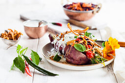 Kumpir (stuffed baked sweet potato) with spinach, carrot and red cabbage salad, raita and homemade chickpea noodles (India)