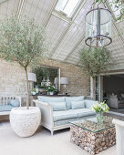 Olive trees in Mediterranean living room with glass roof