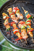 Meat and vegetable skewers on a charcoal barbecue