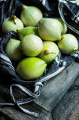 Onions in a black linen bag