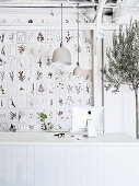 Botanical cards on the wall, olive trees and white desk