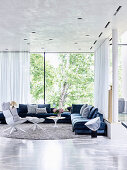 Elegant living room with upholstered furniture and glass front