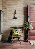 Open wooden door to the hallway in shades of brown with gray wallpaper