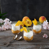 Yoghurt mousse with peaches in glasses