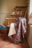 Floral blanket draped over Windsor armchair