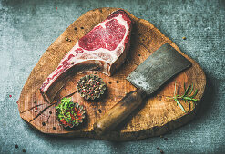 Rohes Dry Aged Ribeye Steak auf rustikalem Küchenbrett