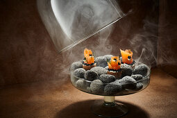 Salmon canapés smoked under a glass cloche