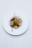 Saddle of milk-fed lamb with a salted almond crust, gorgonzola and rosemary pasta and a tamarind and mustard sauce