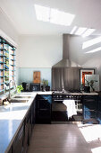 L-shaped kitchen with light coming in through louvre windows