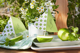 Small sailing boats made from half limes used as name cards