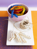 Colourful rubber snakes, string and clothes pegs for Halloween decorations