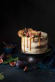 Spiced cake with cream cheese icing, apple crisps, fresh figs and toffee sauce