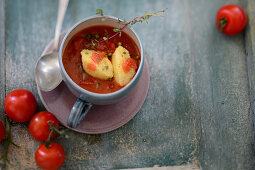 Cold tomato soup with ricotta-semolina dumplings