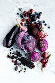 An arrangement of red and purple foods (seen from above)