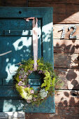 Wreath of flowers with yellow lady's bedstraw, marjoram and grasses