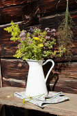 Bunch of wildflowers in white enamel jug