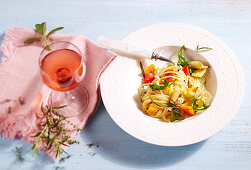 Spaghetto with grilled vegetables served with a glass of rose wine