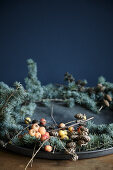 Wreath of blue ceder twigs, cones and crab apples