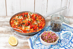 Fish braised in tomato sauce woth pepper and chickpeas