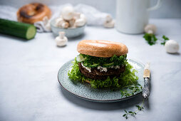 A bagel with a mushroom and seitan patty (vegan)