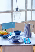 Gedeckter Tisch für Zwei mit Keramikgeschirr mit verschiedenen blauen Dekoren