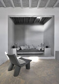 Masonry couch in niche in interior in shades of grey