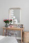 Wooden dressing table, Ghost chair and simple silver-framed mirror