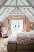 Romantic bedroom with toile de jouy wallpaper and curtains
