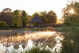 Gartenteich und Pavillon in gepflegtem Landschaftsgarten