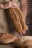 Man holding a freshly baked loaf of bread