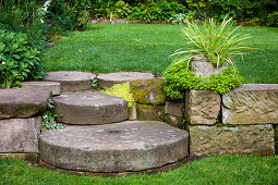Old millstones as steps in the garden with different levels