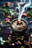 A smoking incense blend in an incense bowl
