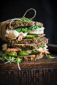 Prawn and avocado sandwich on a crunchy health bread with kombucha in the background