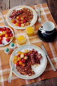 Sweetcorn pancakes with cherry tomatoes and crispy bacon