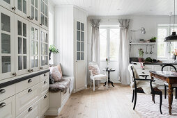 Bench, pantry and dining area in white kitchen-dining room