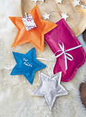 Star and stocking shaped bags sewn from wrapping paper
